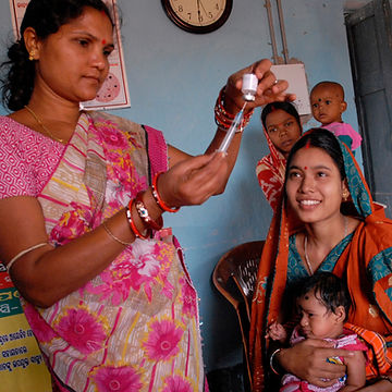 A person holding a dropper and a person holding a baby
Description automatically generated